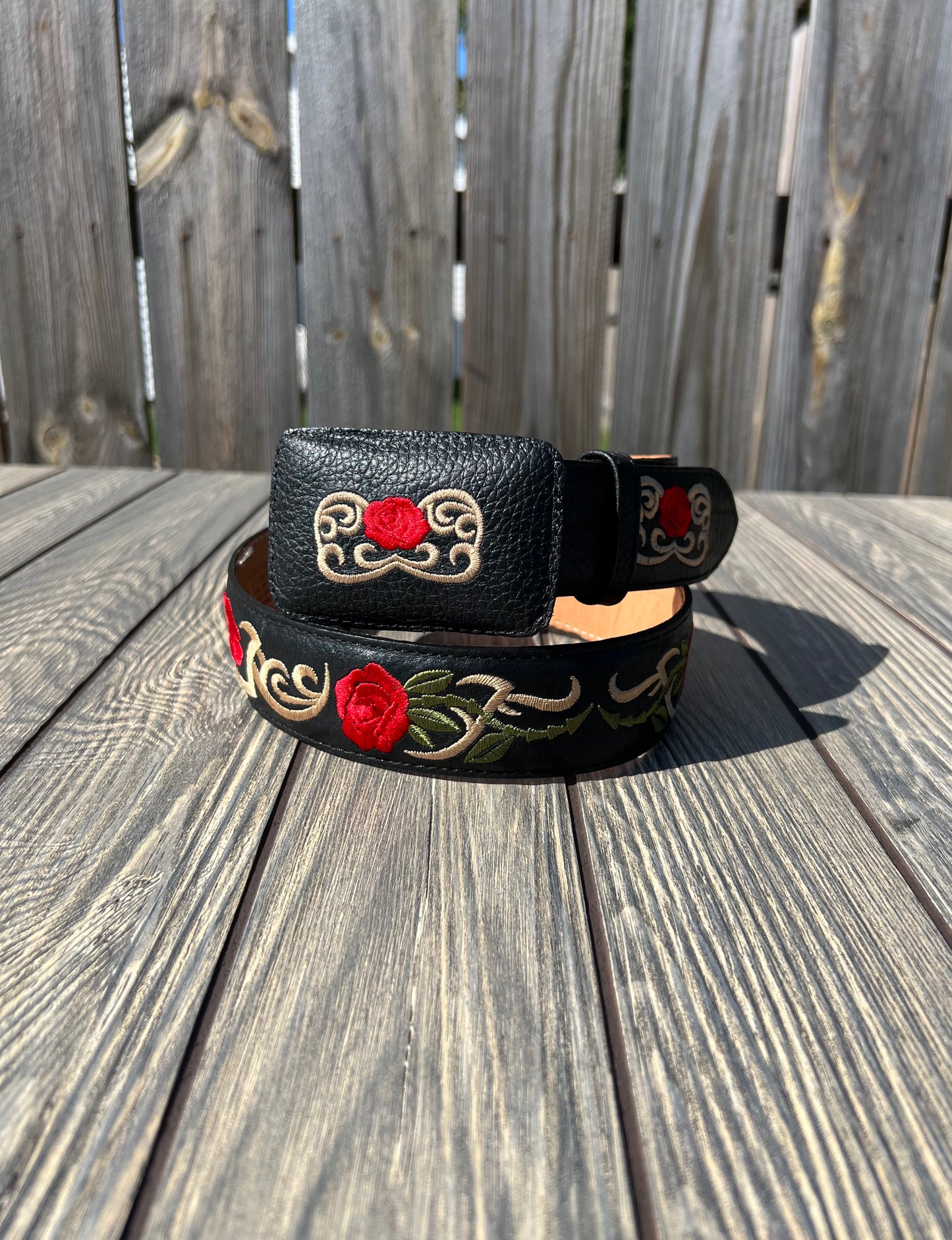 This western woman's belt features an elegant rose designs on a black belt.