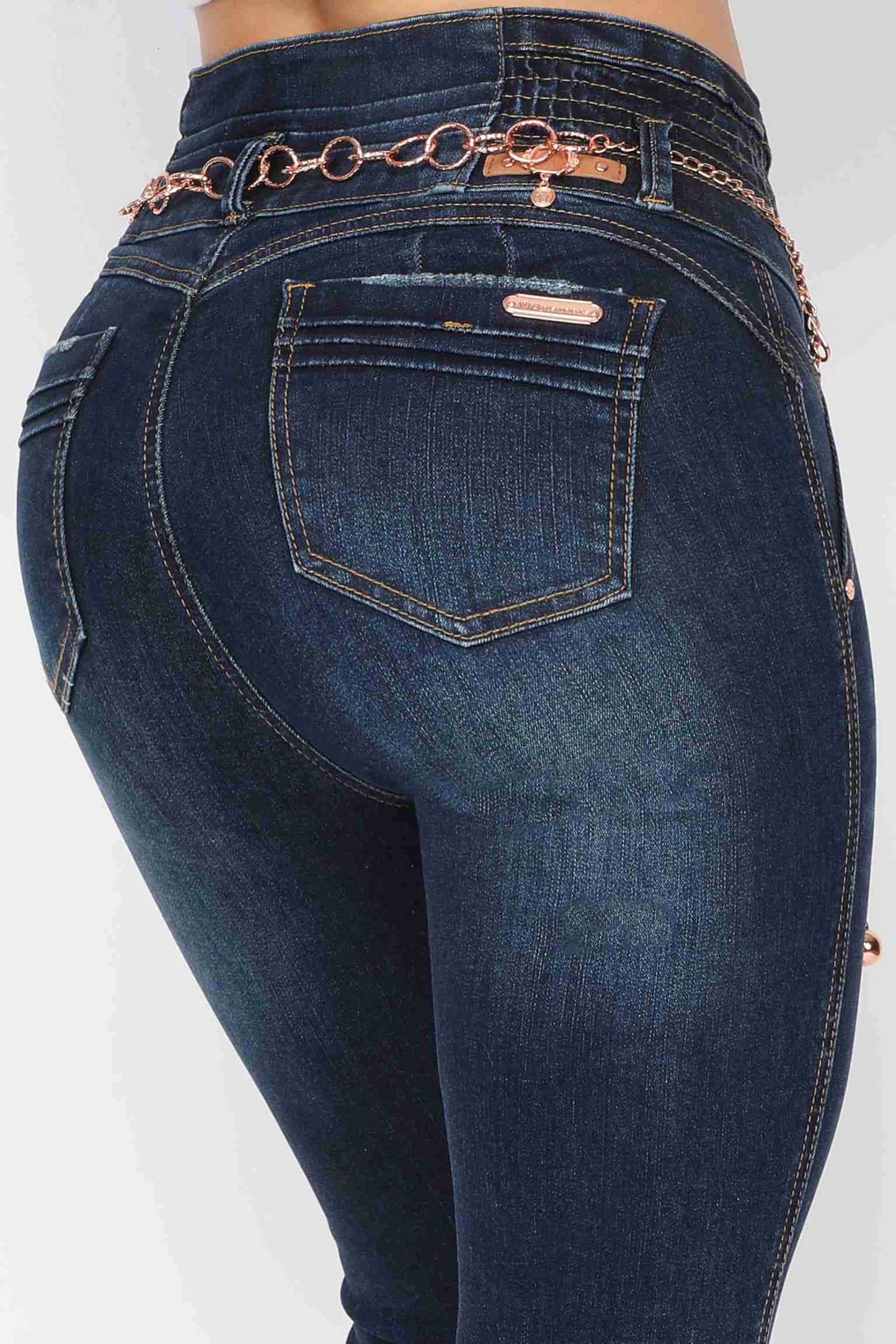 Elevate your style with our Women's Push Up Butt Lifting High Waisted Skinny Colombian Jeans. Crafted with a dark wash denim color and a rose gold sparkly removable belt.