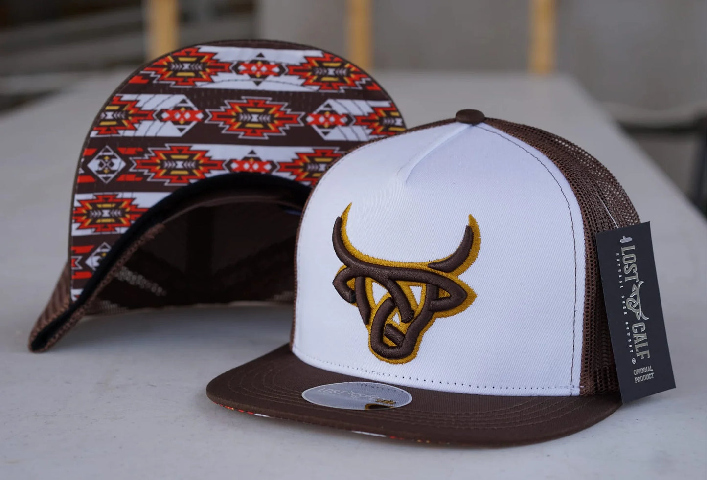 Lost Calf Hat- In the color white and Brown. Lost Calf logo embroidered on front in brown